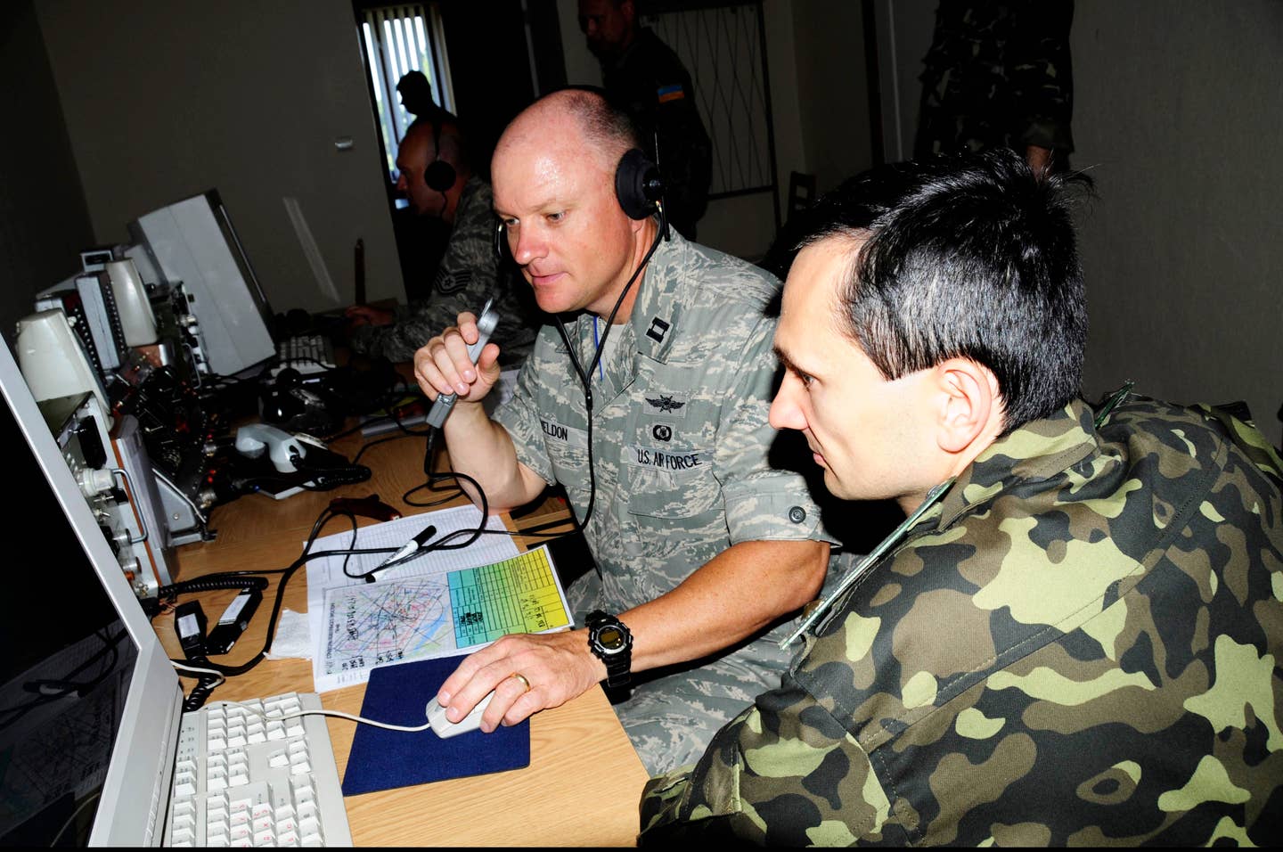 message-editor%2F1647978684162-u.s._air_force_capt._john_weldon_left_works_with_his_ukrainian_air_force_counterpart_in_the_ground_control_intercept_cell_at_mirgorod_air_base_ukraine_july_20_2011_during_safe_skies_2011_110720-a-zz999-010.jpg