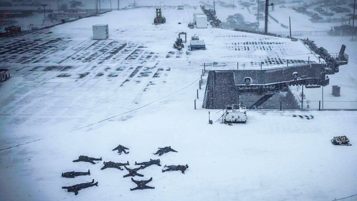 Sailors Make Snow Angels On Deck Of Supercarrier During Storm