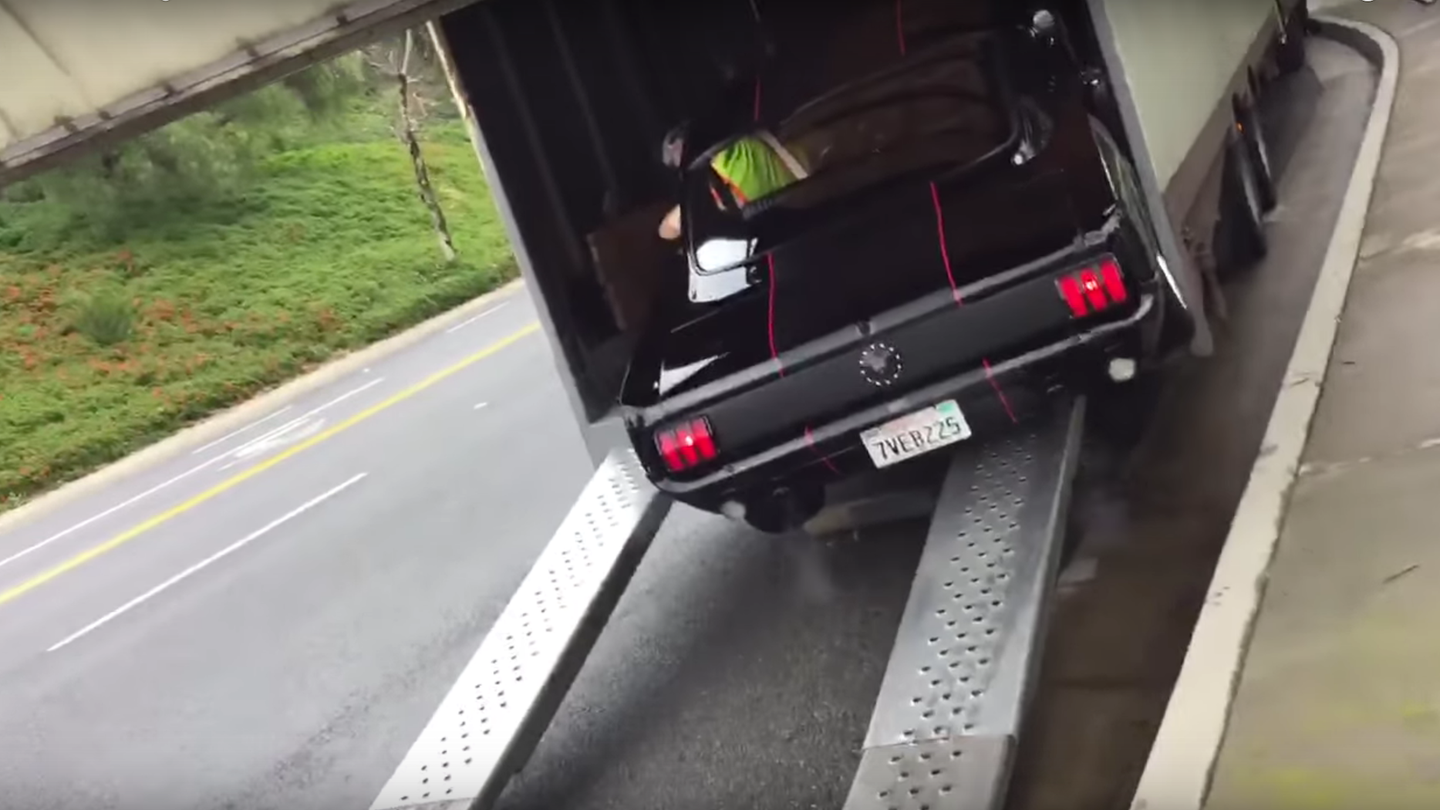 Watch This Classic 1965 Ford Mustang Crash Its Way Onto a Trailer