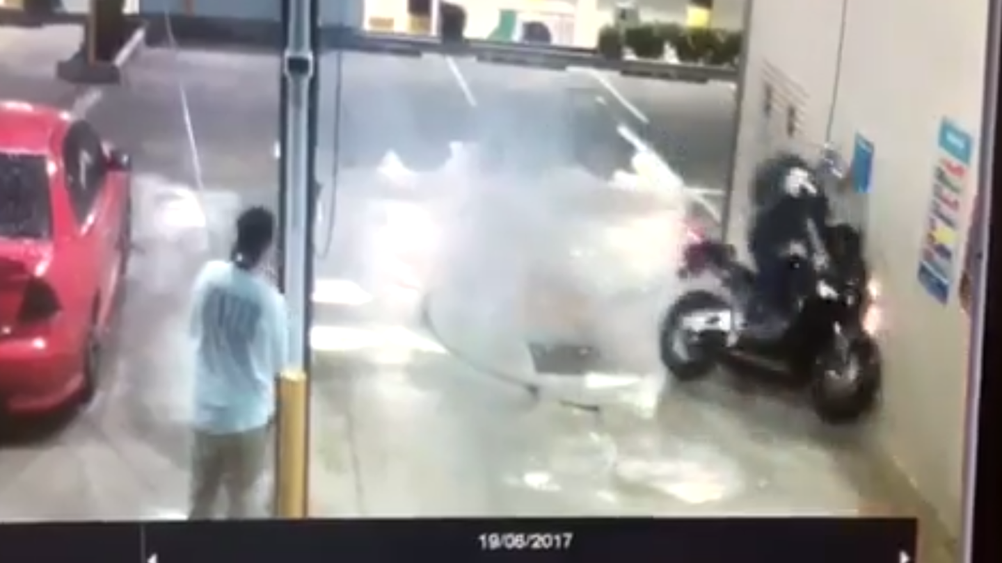 Watch This Moron Crash Doing a Motorcycle Donut in a Car Wash
