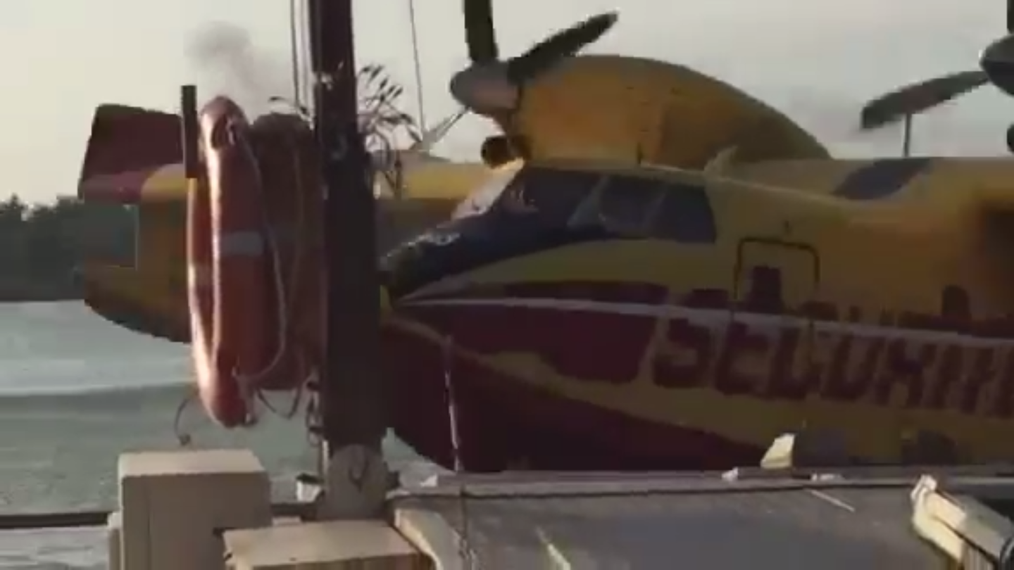 Watch a Canadair CL-415 Water Bomber Clip a Barge During a River Takeoff