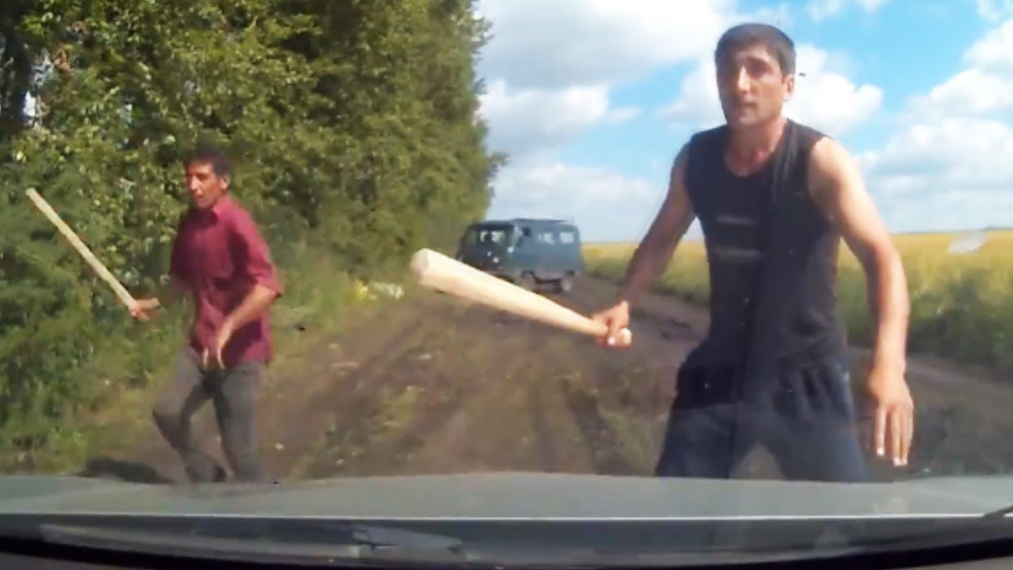 Dash Cam Footage Shows Driver Narrowly Escaping a Roadblock Robbery in Russia
