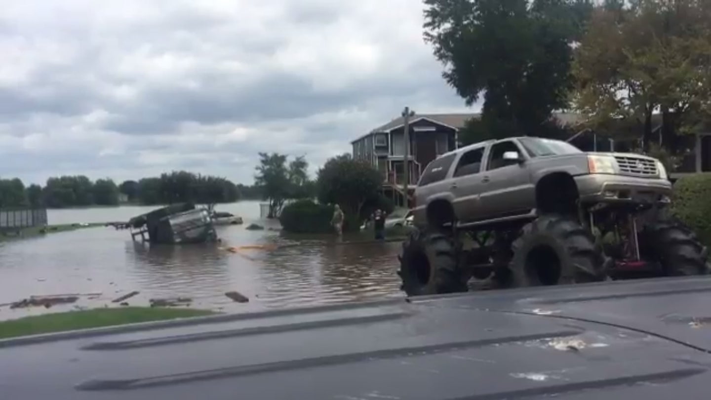 Watch a Lifted Cadillac Escalade Pull a Military Truck Out of Harvey’s Floodwaters