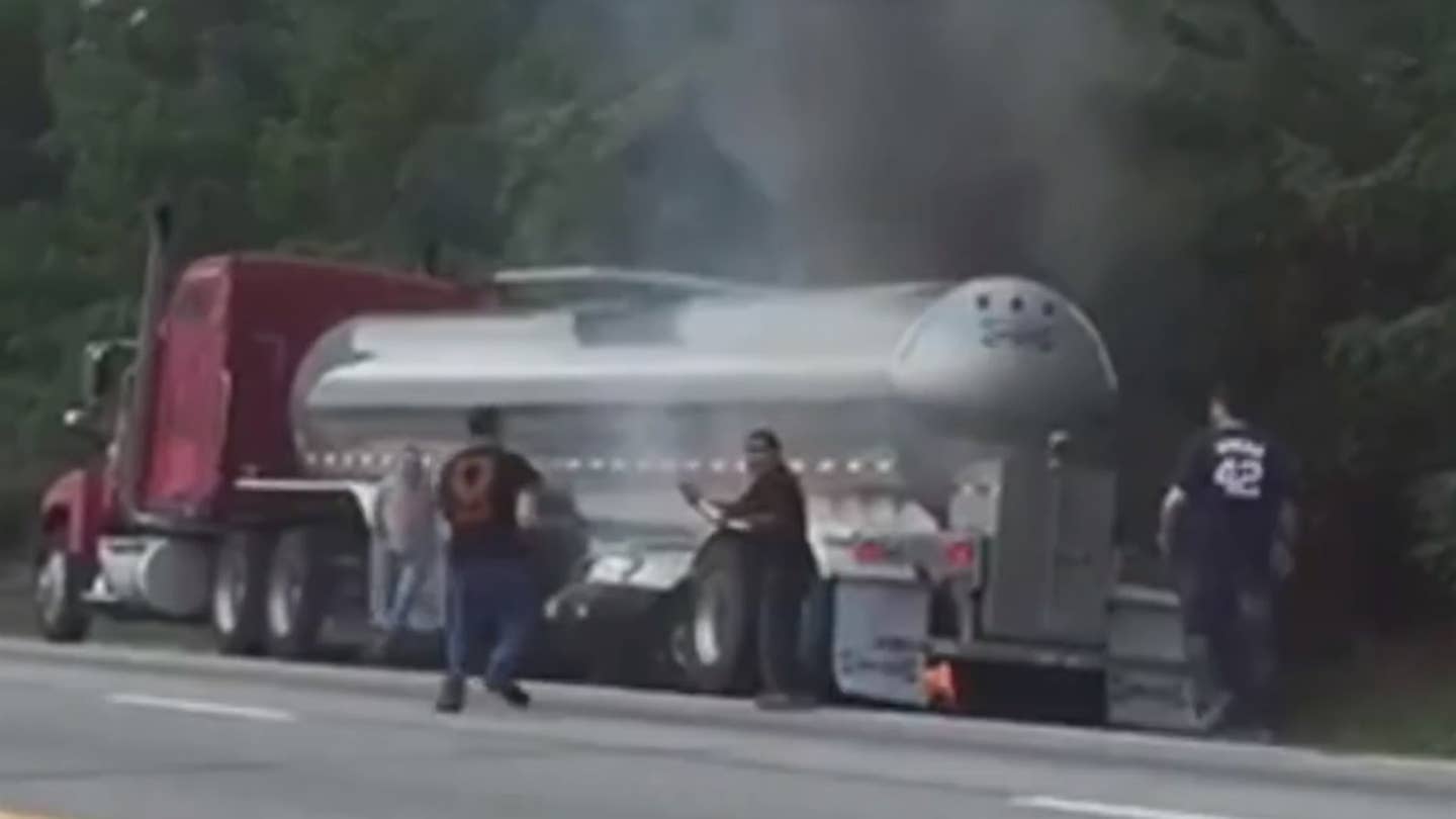 Witnesses Leap Into Action to Save Elderly Couple from Burning Car Under Tanker Truck