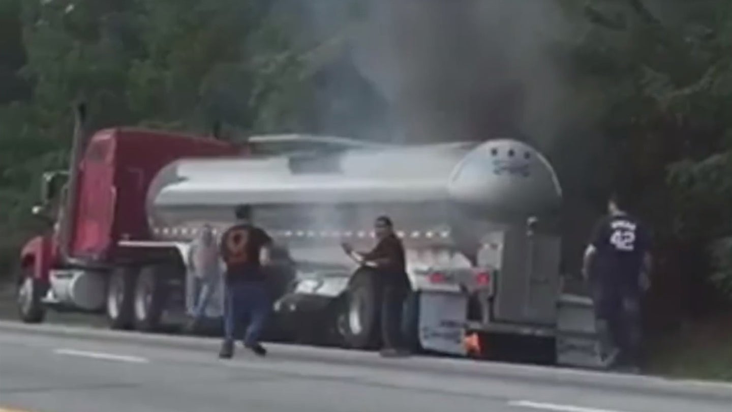 Witnesses Leap Into Action to Save Elderly Couple from Burning Car Under Tanker Truck