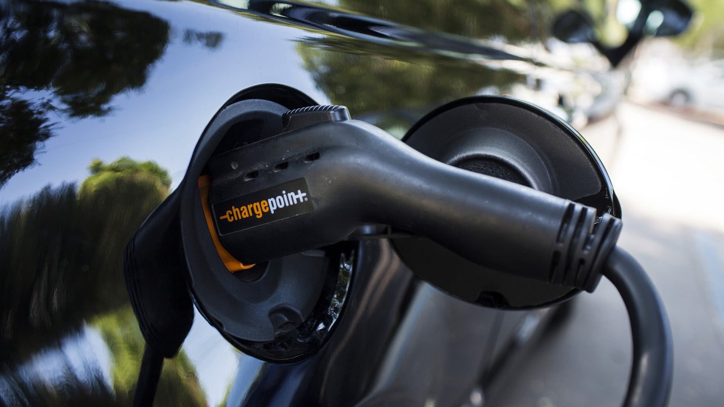 A ChargePoint Inc. charging plug sits connected to an electric vehicle (EV) at a station in Los Angeles, California, U.S., on Tuesday, July 11, 2017. City Council committee signed off financing for a program to provide more than $1.1 million in funding to add dozens of EV charging stations around the city in addition to the 560 already in place at city facilities and street locations. Photographer: Dania Maxwell/Bloomberg