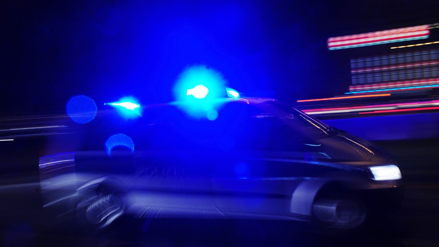 A police car with lights flashing is pic