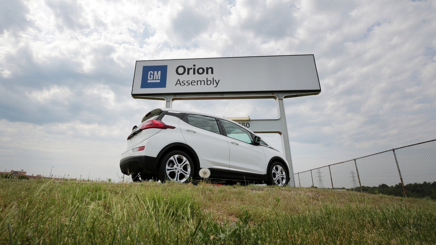 A Chevrolet Bolt vehicle is displayed next to signage outside the General Motors Co. Orion Assembly Plant in Orion Township, Michigan, U.S., on Tuesday, June 13, 2017. The largest U.S. automaker will expand its fleet of autonomous Chevrolet Bolts to 180 of the electric vehicles, Chief Executive Officer Mary Barra said Tuesday. Photographer: Jeff Kowalsky/Bloomberg