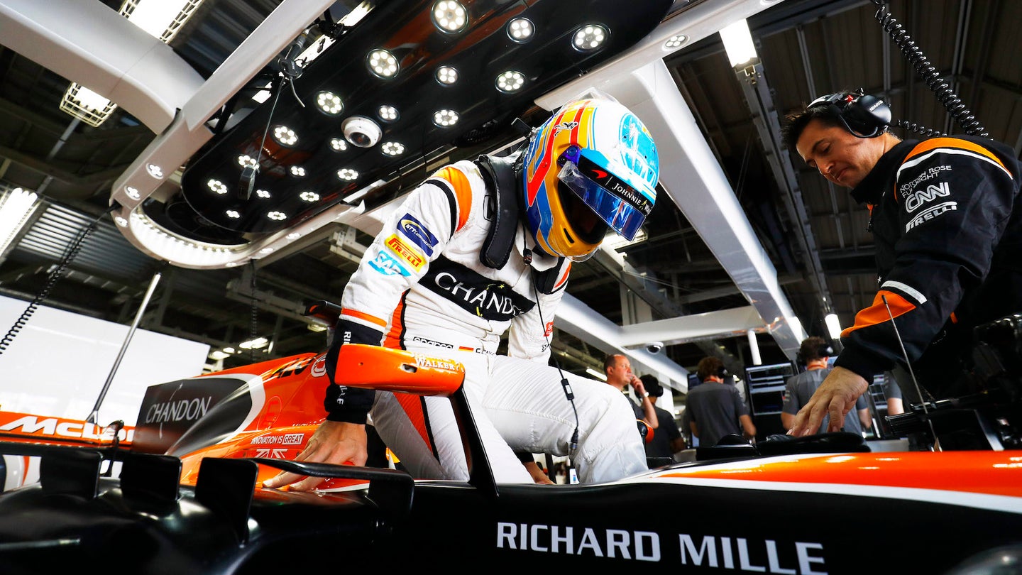 Suzuka Circuit, Japan.Sunday 8 October 2017.Fernando Alonso, McLaren, climbs in to his seat in the garage.Photo: Steven Tee/McLarenref: Digital Image _R3I7668