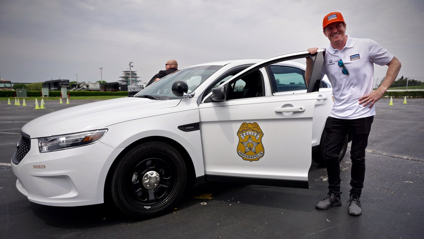 IndyCar Champ Scott Dixon Wheels a Police Car at Indianapolis Motor Speedway