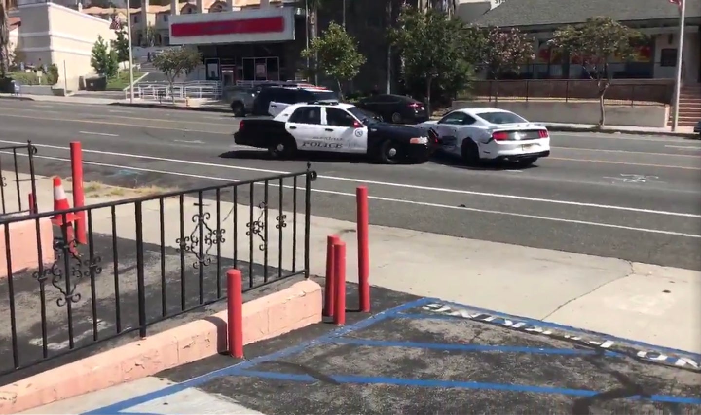 Alleged Shoplifter Rams White Ford Mustang Into Police, Evades Capture