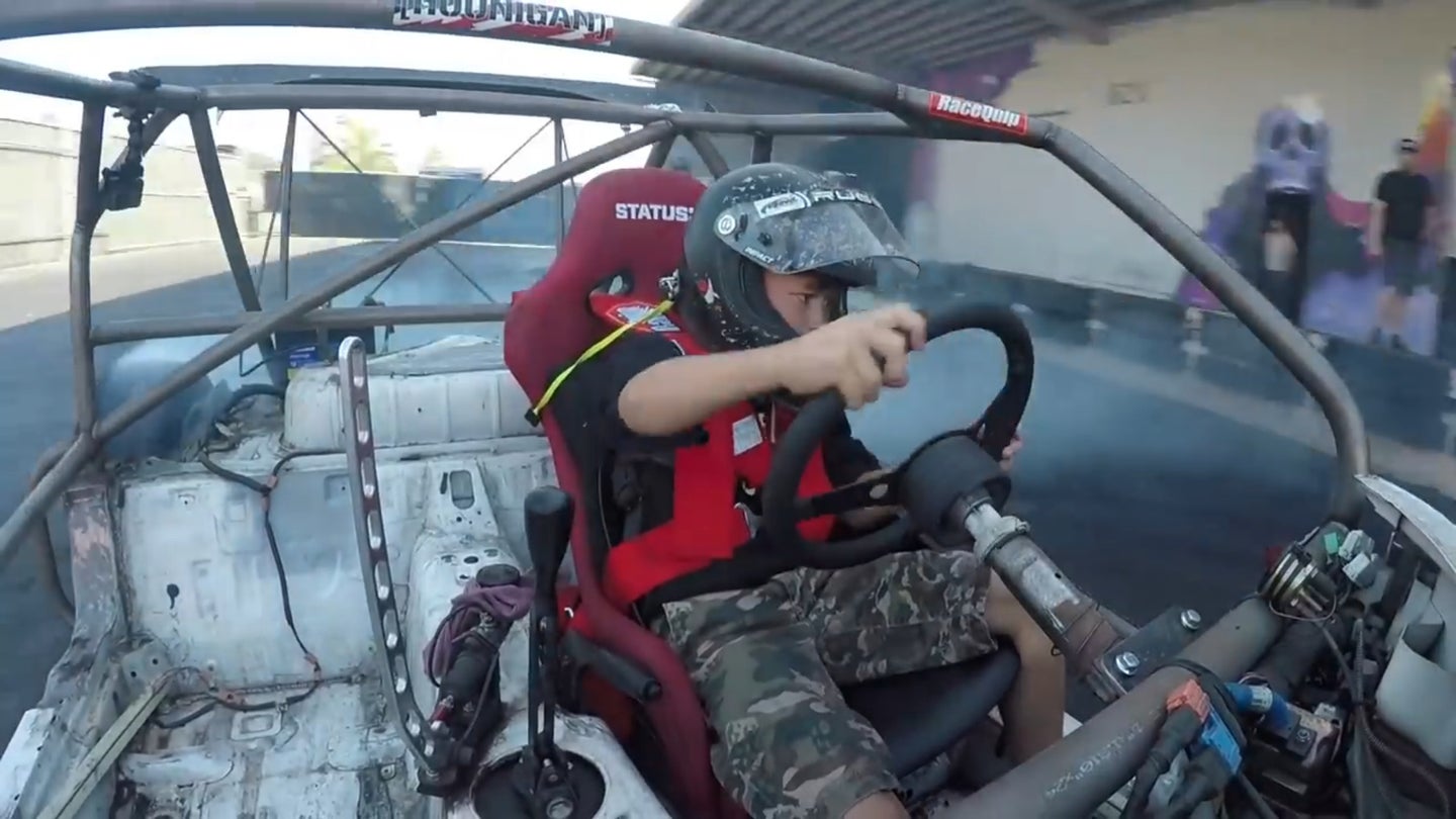 Nine-Year-Old Learns To Drive Stick in 30 Seconds and Immediately Does Rad Donuts
