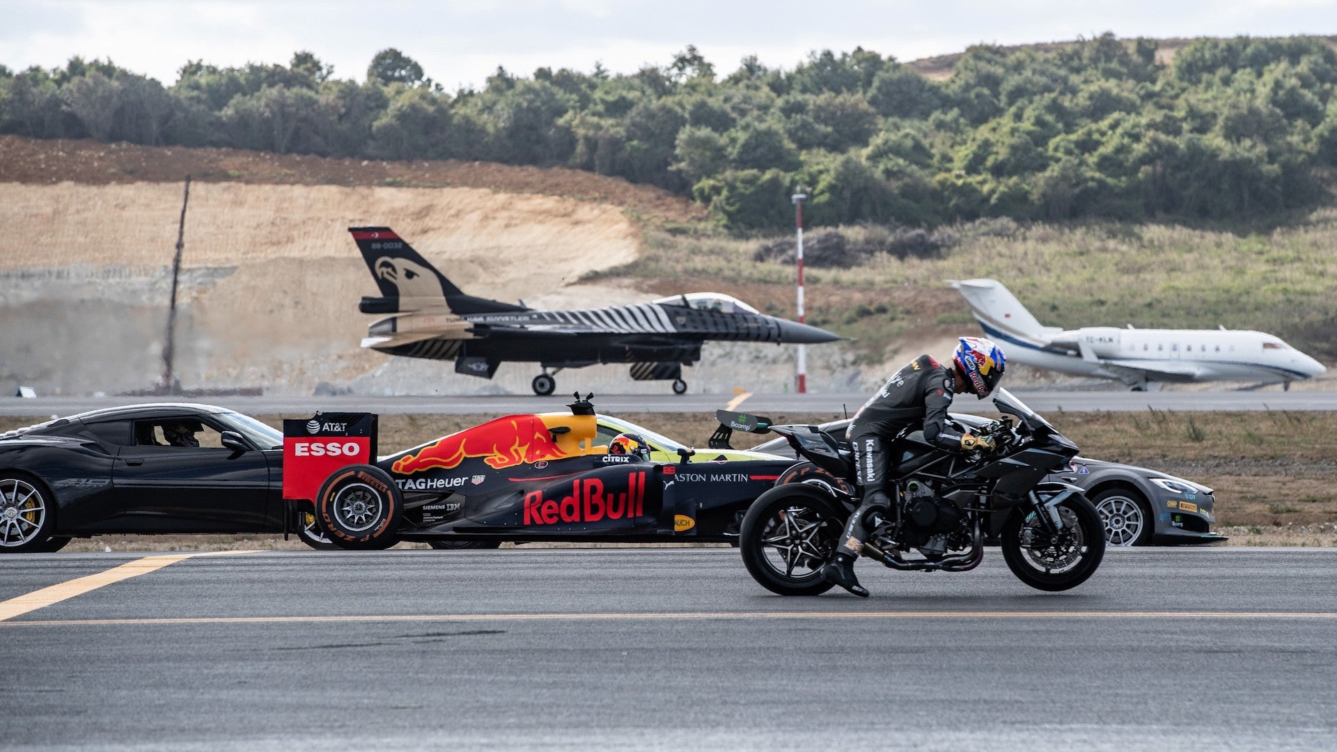 watch this kawasaki ninja h2r drag race a fighter jet f1 car and a modified tesla