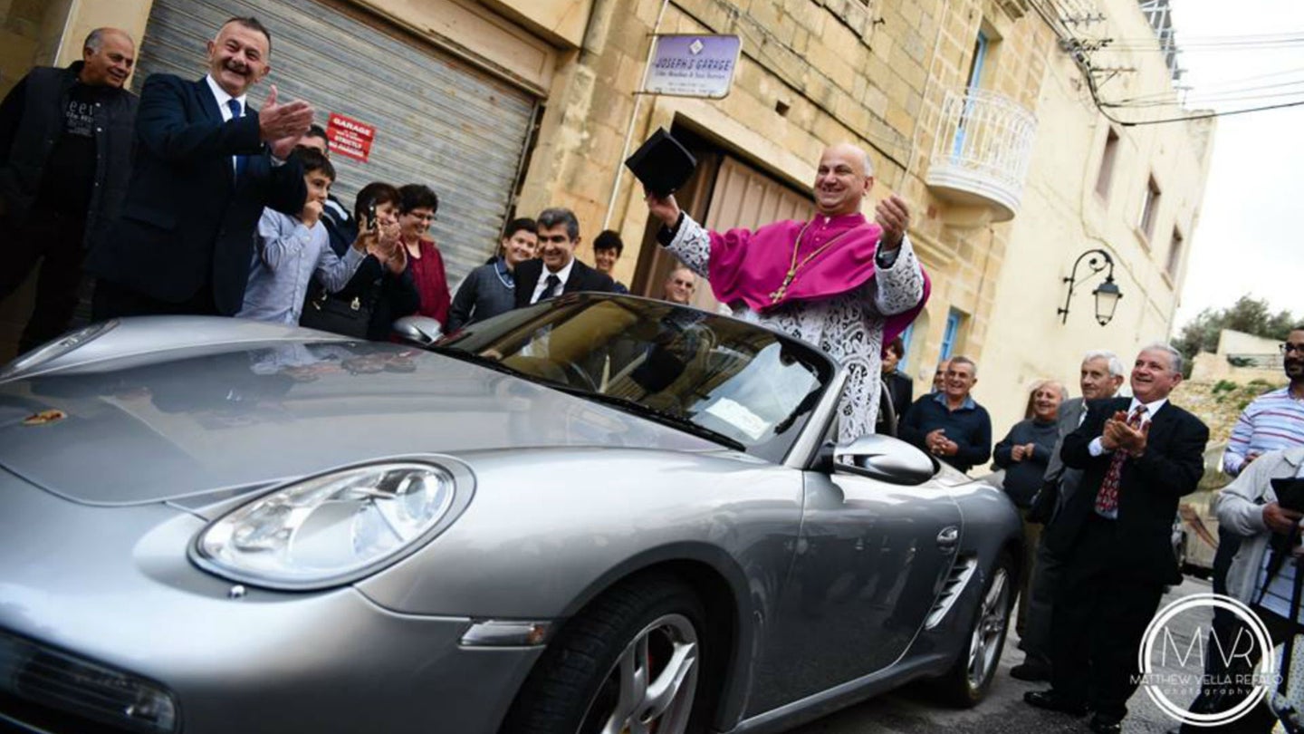 Watch Dozens of Kids Tow Catholic Priest in Porsche Boxster During Awkward Inauguration