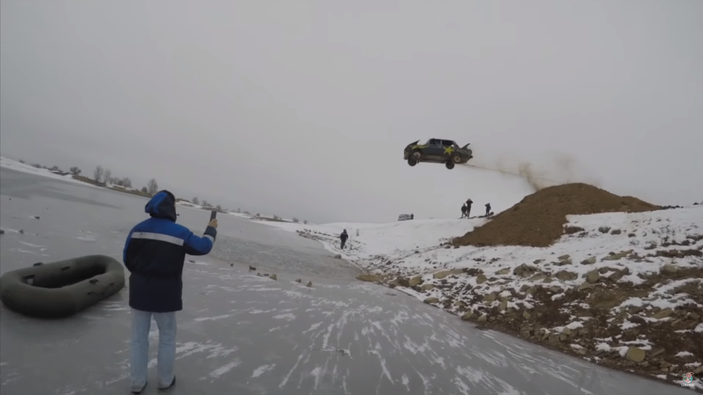 Watch Some Crazy Russians Jump a Burning Car Into a Frozen Lake