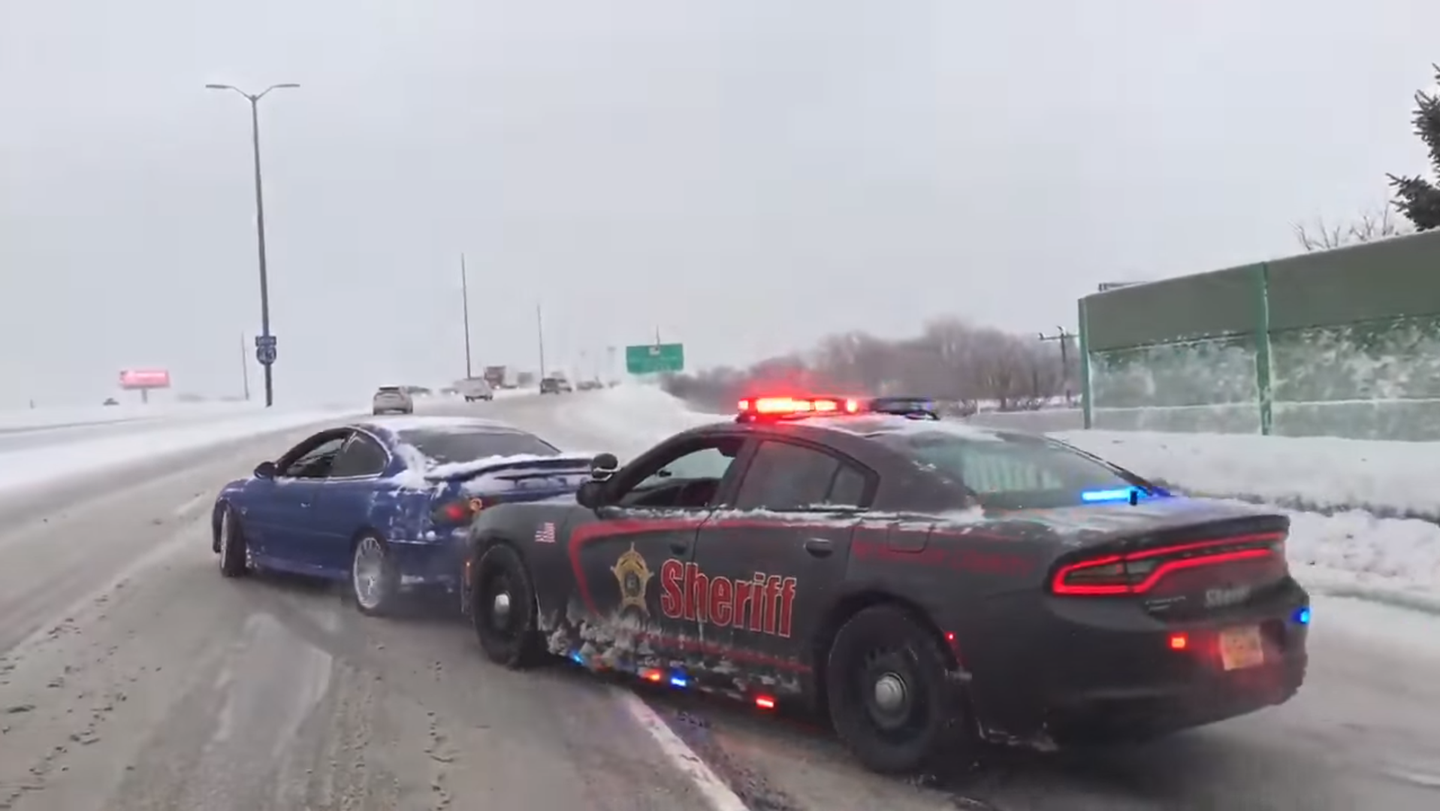 Watch a Cop Play Bumper Cars to Nudge a Pontiac GTO Down a Snowy Interstate