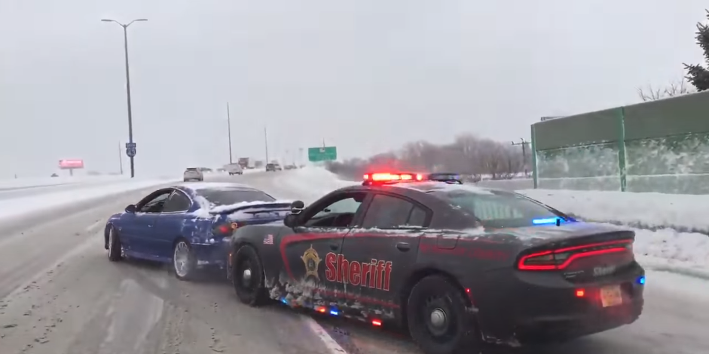 Watch a Cop Play Bumper Cars to Nudge a Pontiac GTO Down a Snowy Interstate