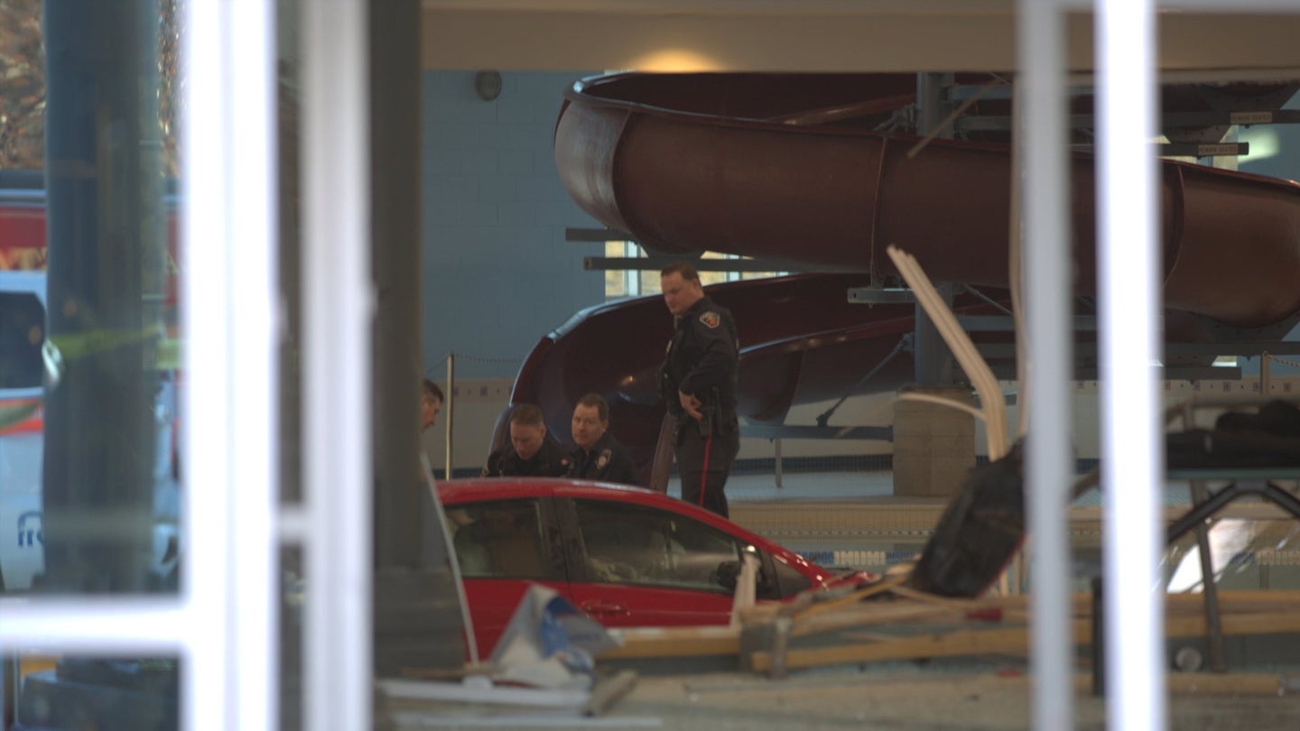 Woman Rams Toyota Yaris Into Building Lobby, Narrowly Avoids People Before Crashing Into Pool