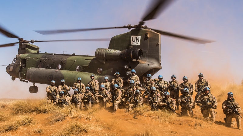 Canadian Troops Pose With Chinook As It Sticks A Pinnacle Landing While On Deployment In Mali