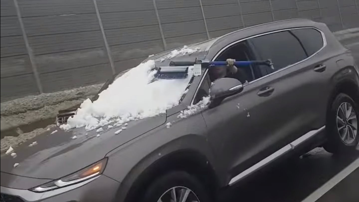 Watch This Clueless Driver Clear Her Windshield of Snow on a Busy Interstate