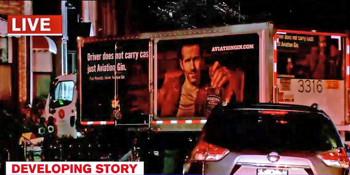 Truck Bearing Ryan Reynolds&#8217;s Smug Face Sideswipes Cars, Crashes Into House to Avoid Cat