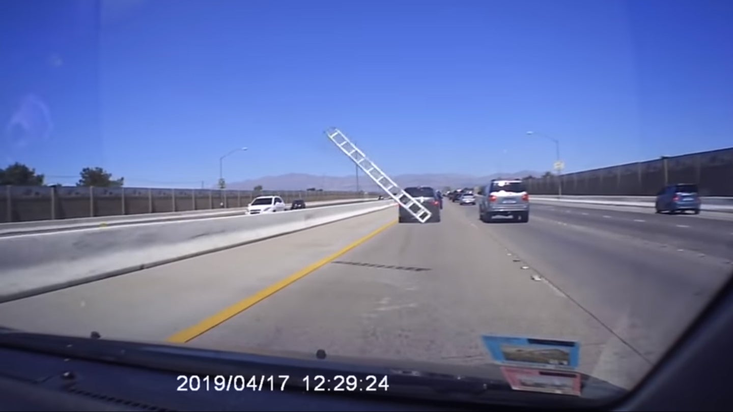Watch a Huge Metal Ramp Fly Across the Highway and Violently Crash Into a Car