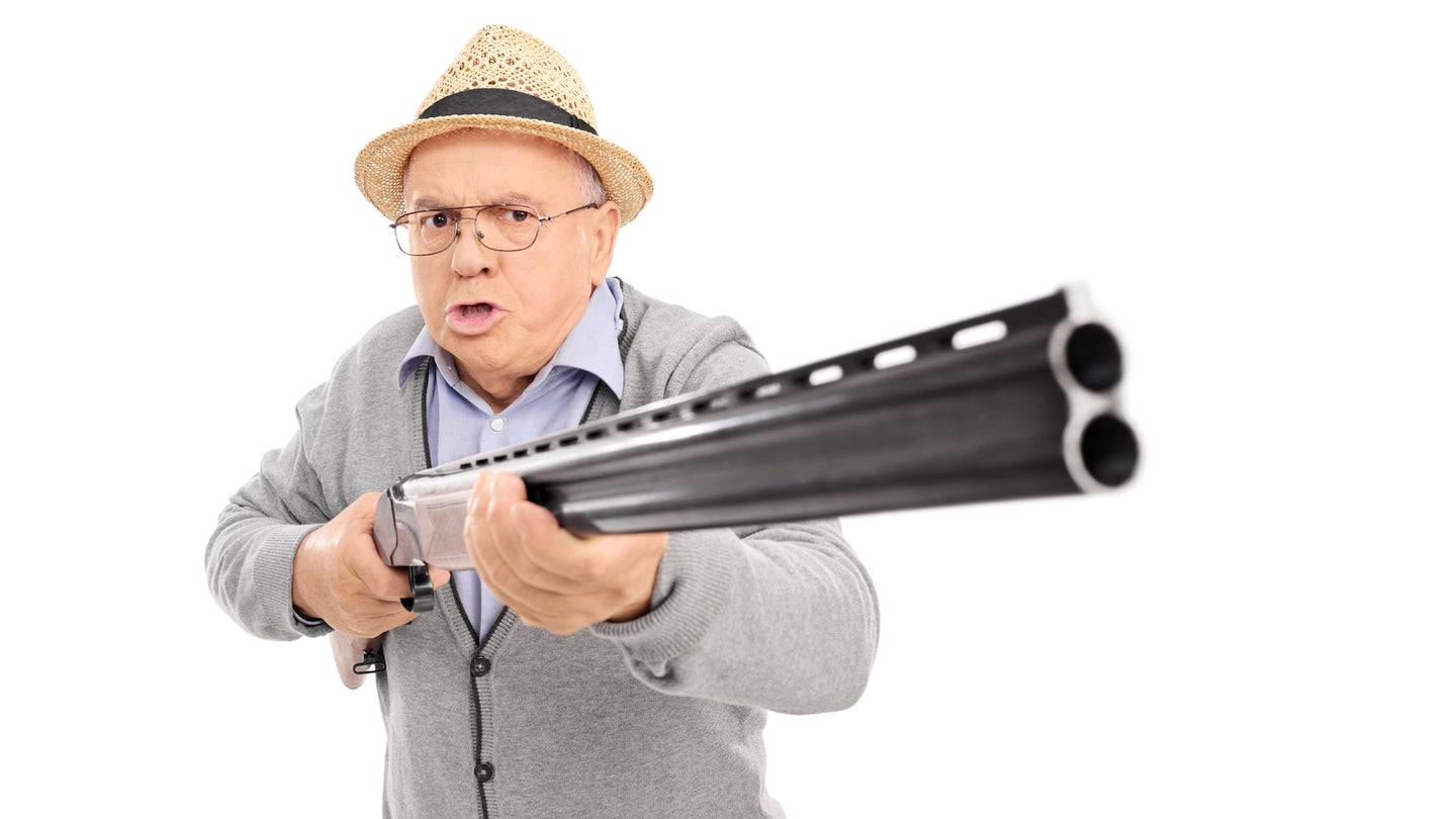 Furious senior man holding a shotgun