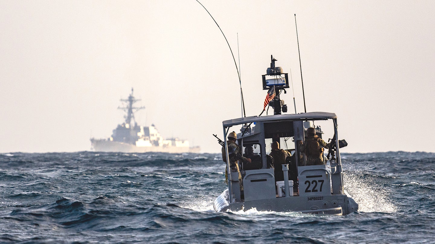 A patrol boat from Coastal Riverine Squadron 1 sails toward the USS Forrest Sherman off Djibouti.