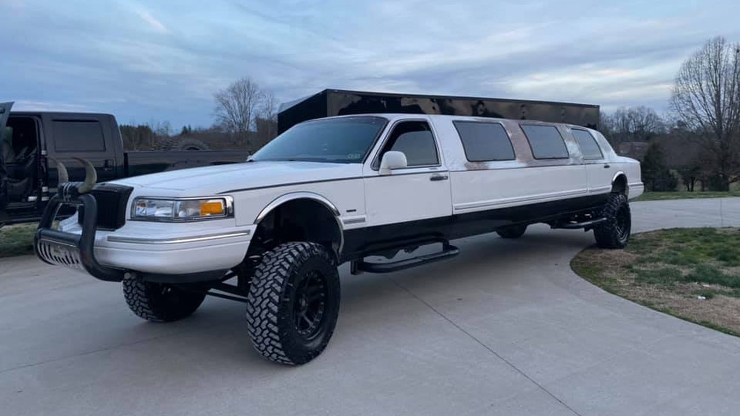 Nothing Says Class Like a Lifted Lincoln Town Car Limo With a Cowhide Wrap and Bull Horns
