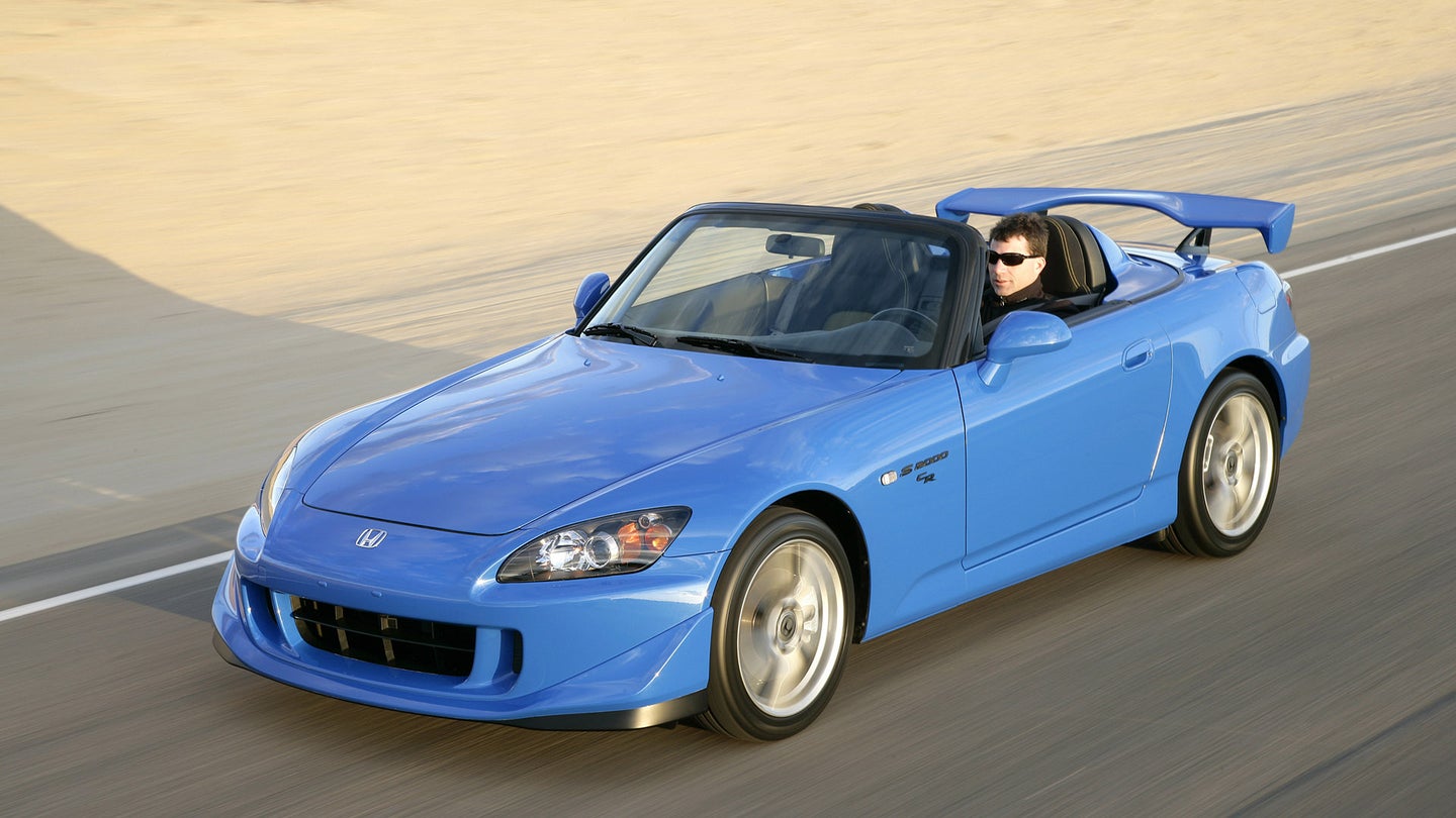 A baby blue Honda S2000 CR Prototype in motion.
