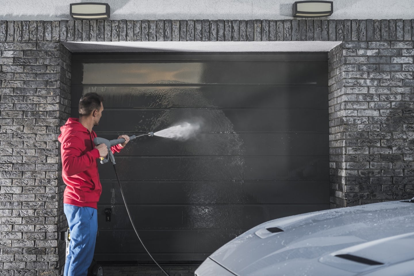 Cleaning garage door and car with pressure washer