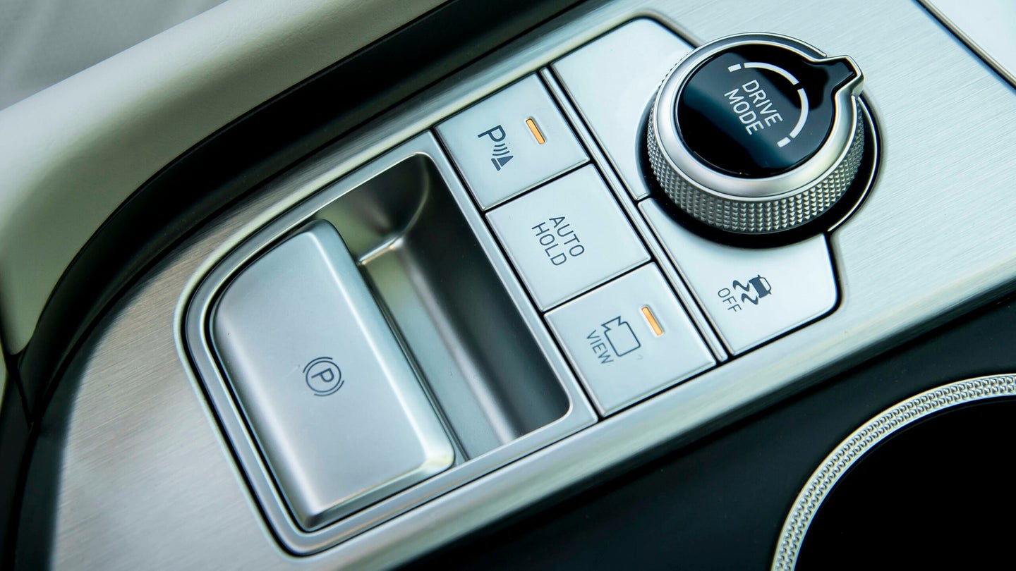 A close-up of a Genesis G70 gear selector and parking brake.