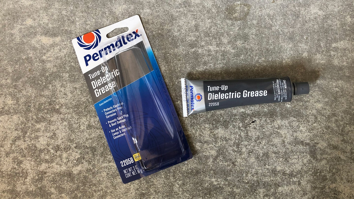 A tube of Permatex dielectric grease on concrete.