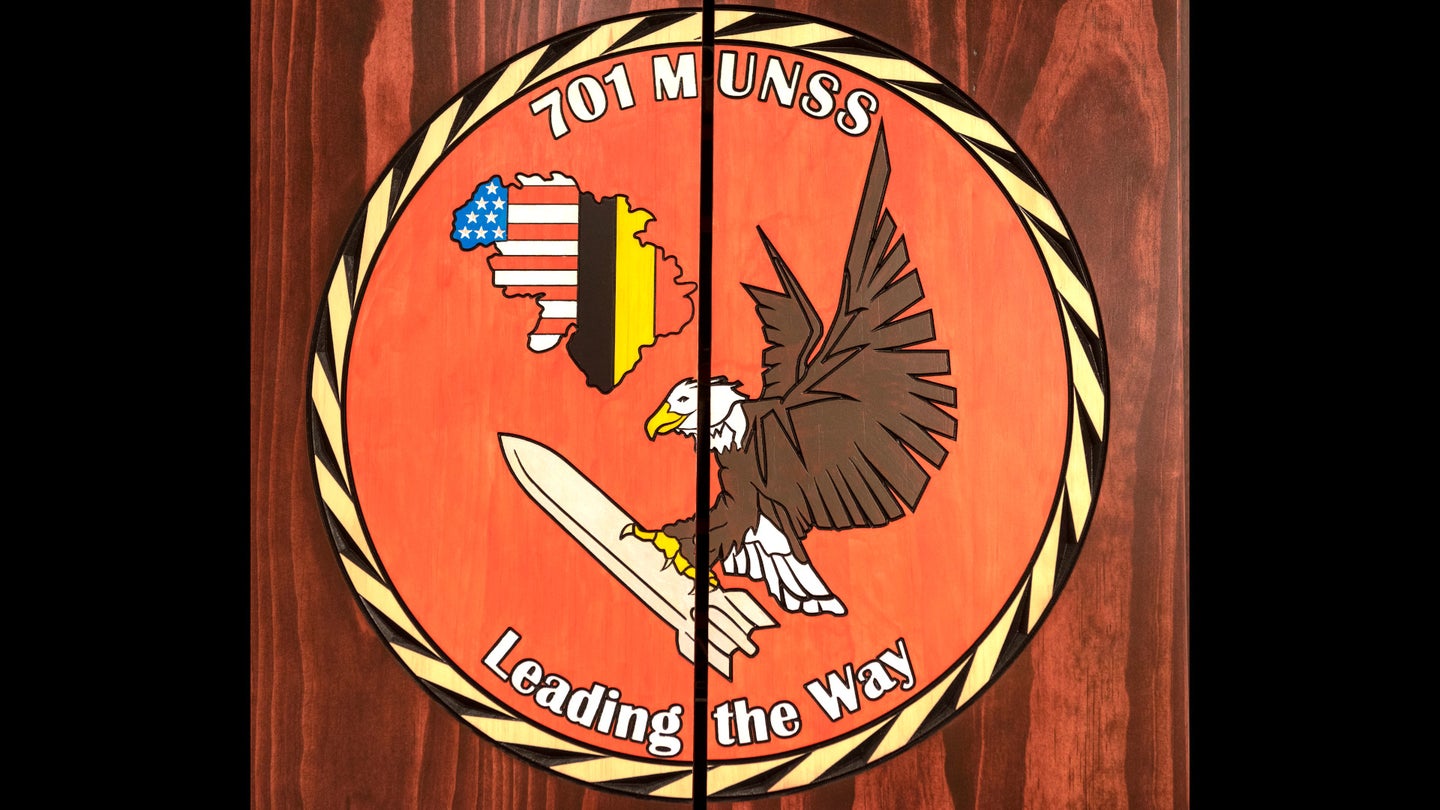 A logo seen in a conference room within facilities that the 701st Munitions Support Squadron operates at Kleine Brogel Air Base in Belgium.