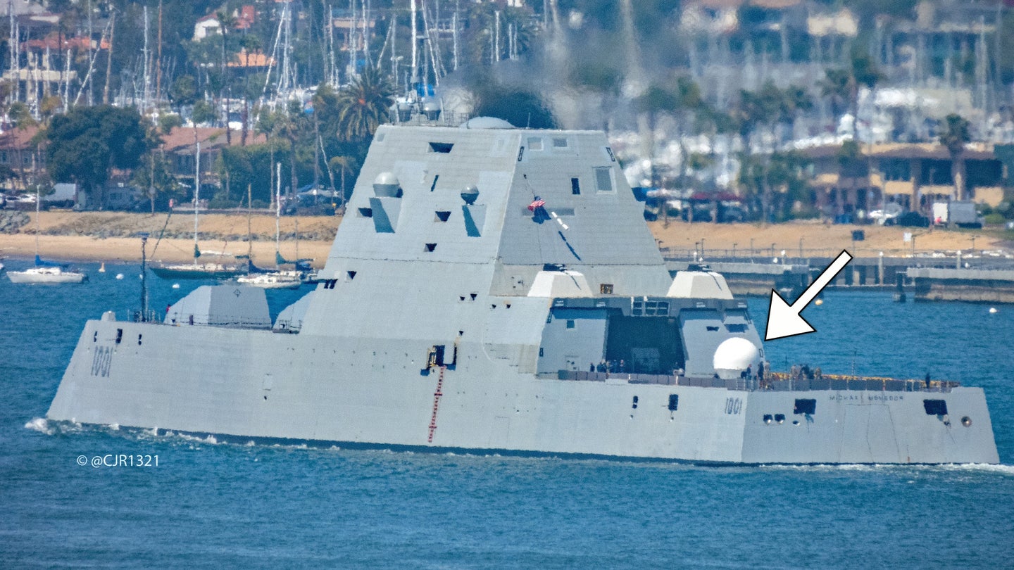 The Zumwalt class stealth destroyer USS Michael Monsoor spotted leaving San Diego on Apr. 20, 2021, with a large satellite communications dome on its rear flight deck.