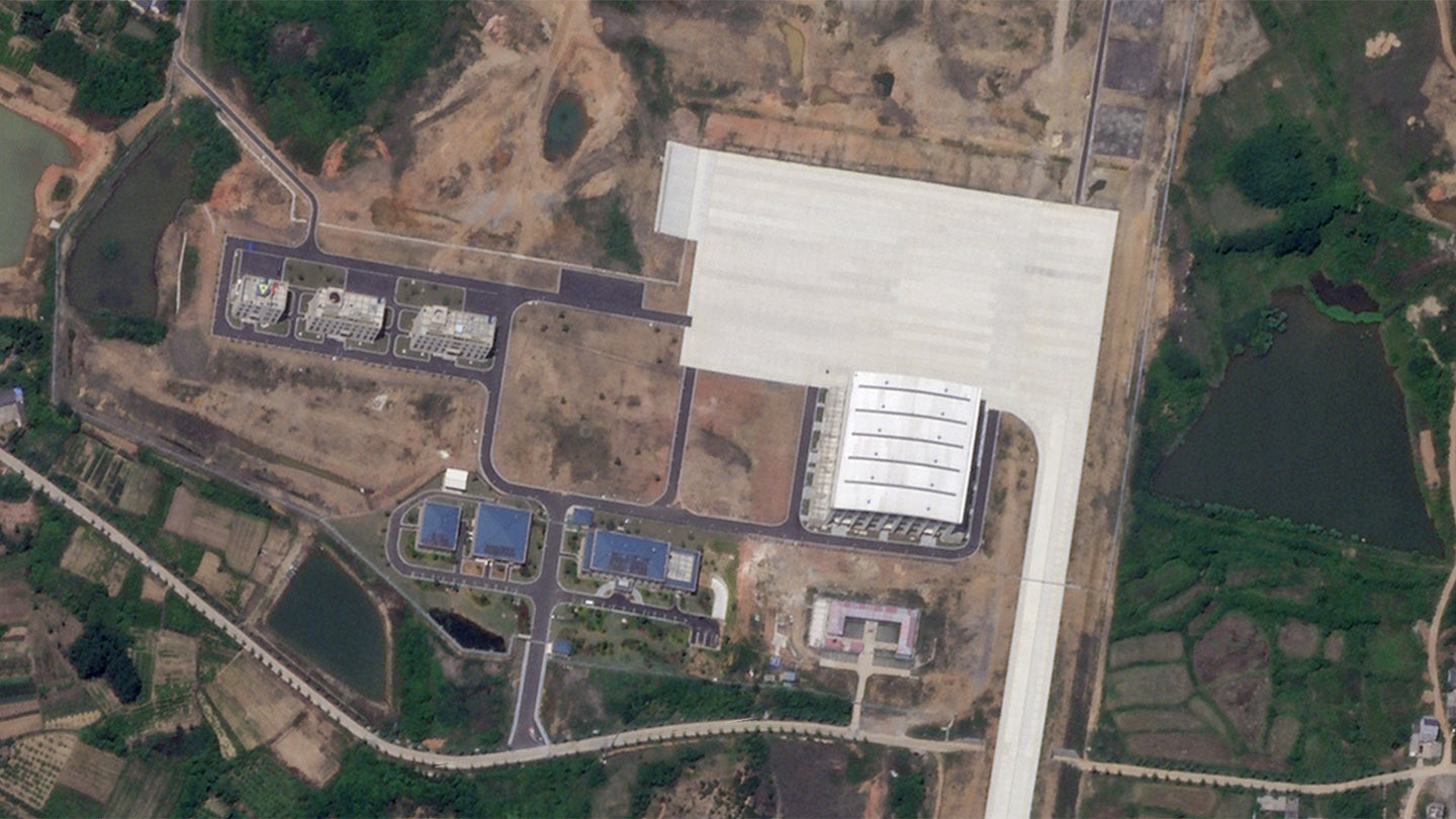 A satellite image showing a large hangar and associated infrastructure at a detached extension at the PLAAF's Luhe-Ma'an Air Base.
