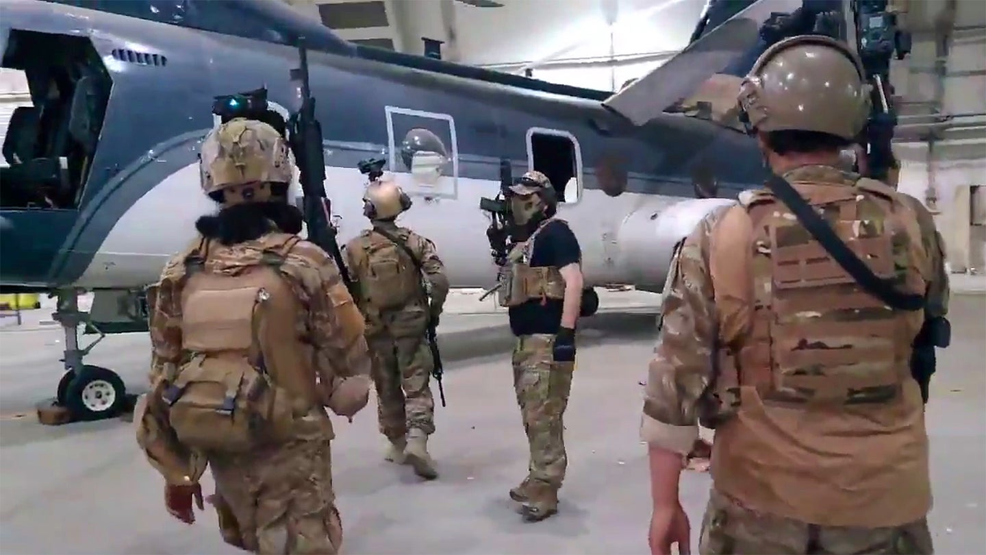 A screengrab from a video show members of the Taliban inspecting abandoned former US State Department CH-46E Sea Knight helicopters in a hangar at Hamid Karzai International Airport following the final withdrawal of American troops on Aug. 31, 2021.