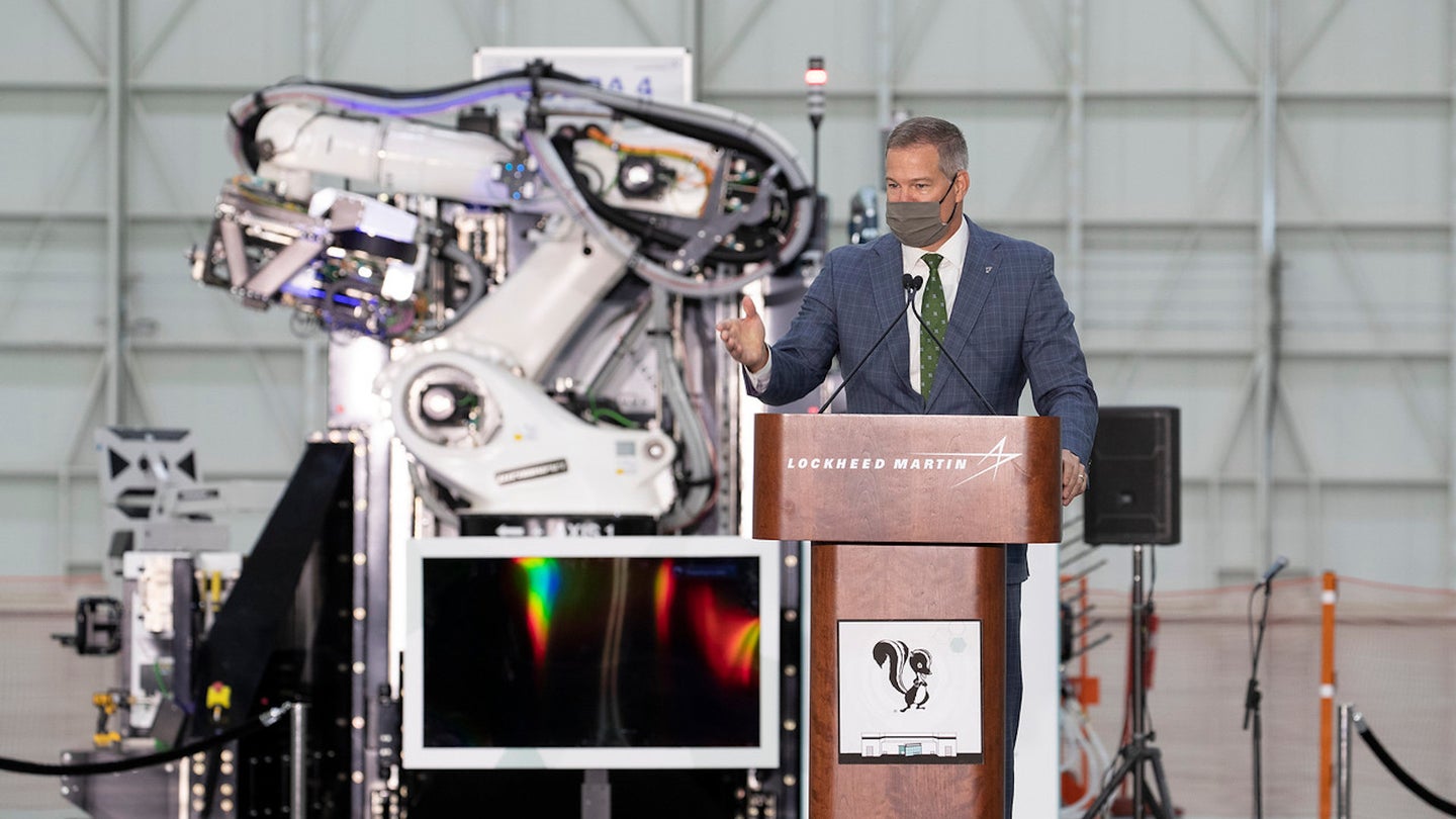 Jeff Babione, Vice President and General Manager of Lockheed Martin's Skunk Works, speaks in front of an advanced manufacturing robot at the ribbon-cutting ceremony for the new Building 648 manufacturing facility.
