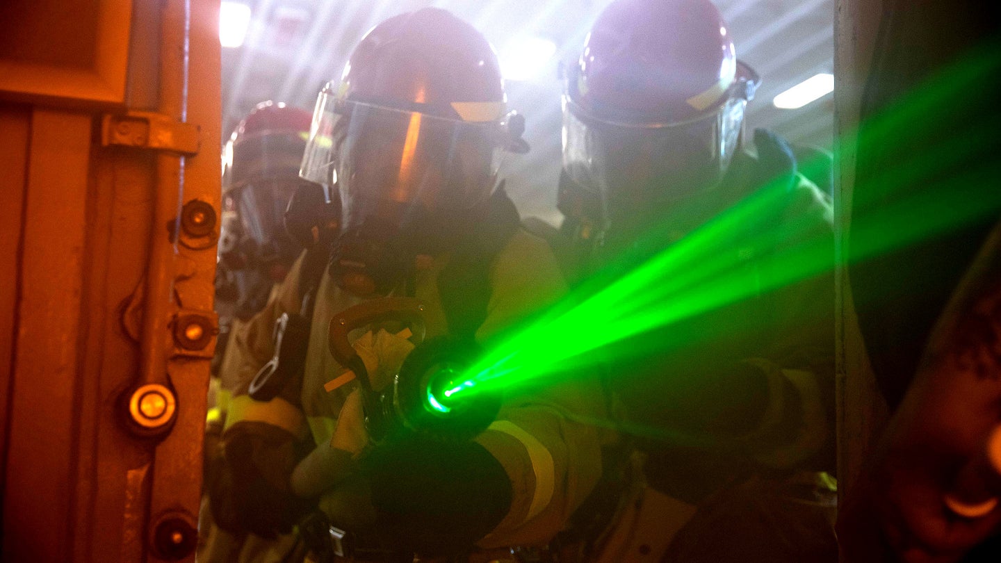 Here Is Why This Sailor Is Holding A Laser Fire Hose