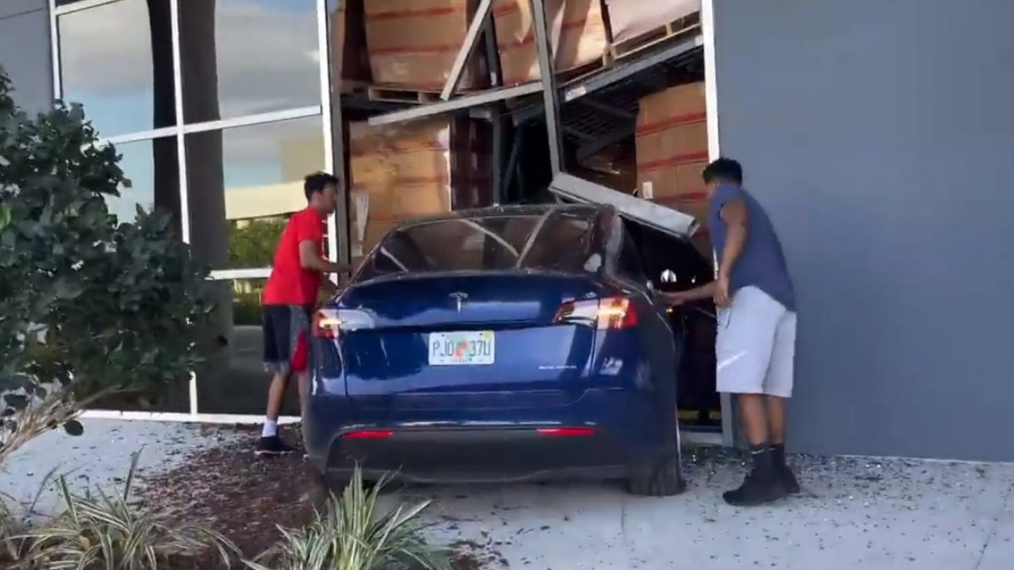 Watch Someone Crash a Tesla Into a Warehouse at High Speed