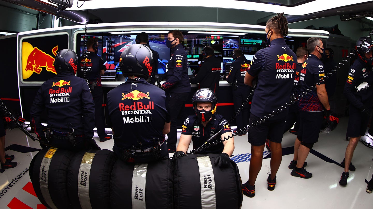 Red Bull pit crew mechanics and engineers in the back of their garage during the Russian Grand Prix