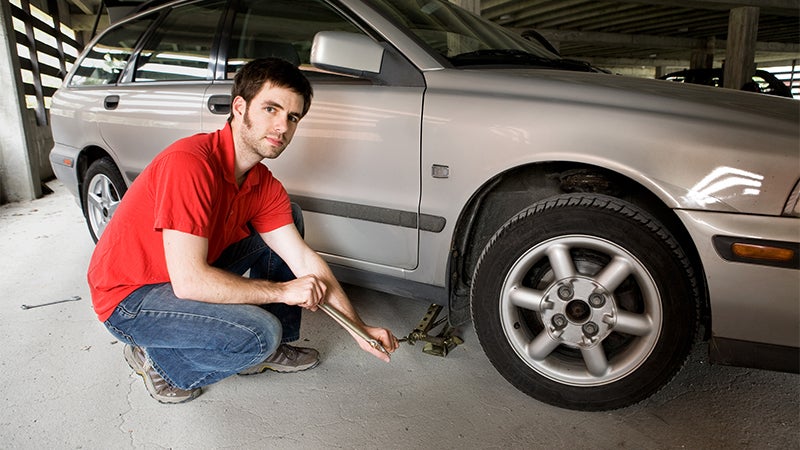 man changing tire in garage