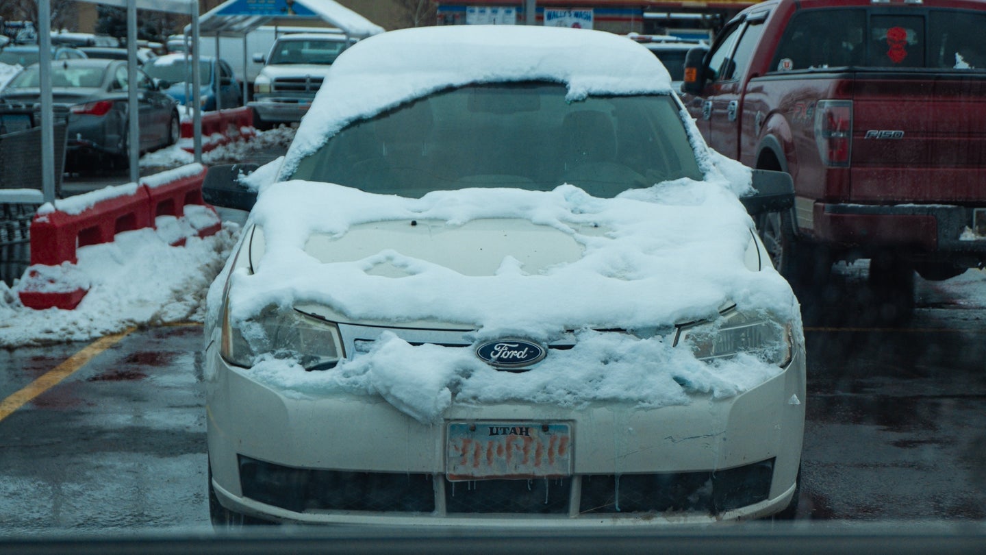 A Ford Focus partially cleaned of snow.