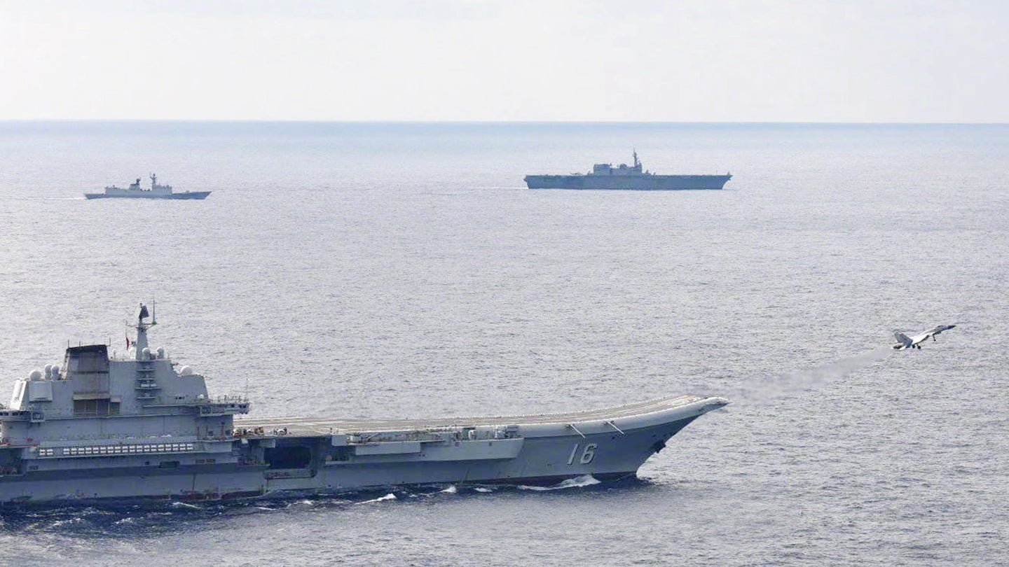 A picture showing the Japanese aircraft carrier Izumo, at top left, sailing relatively close to China's aircraft carrier Liaoning, as well as another People's Liberation Army Navy warship.