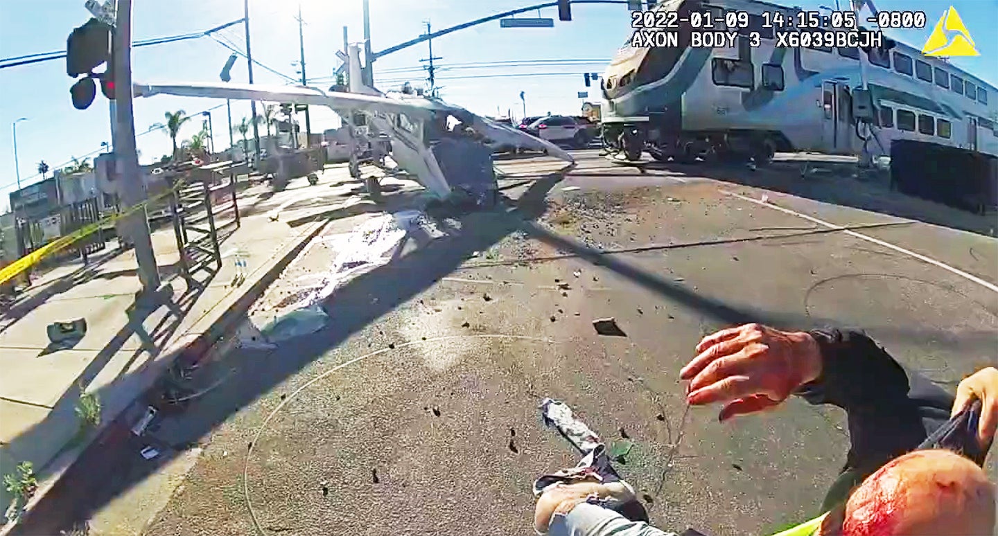 Pilot Pulled From Crashed Plane Just Before Train Obliterates It In Incredible Body Cam Video