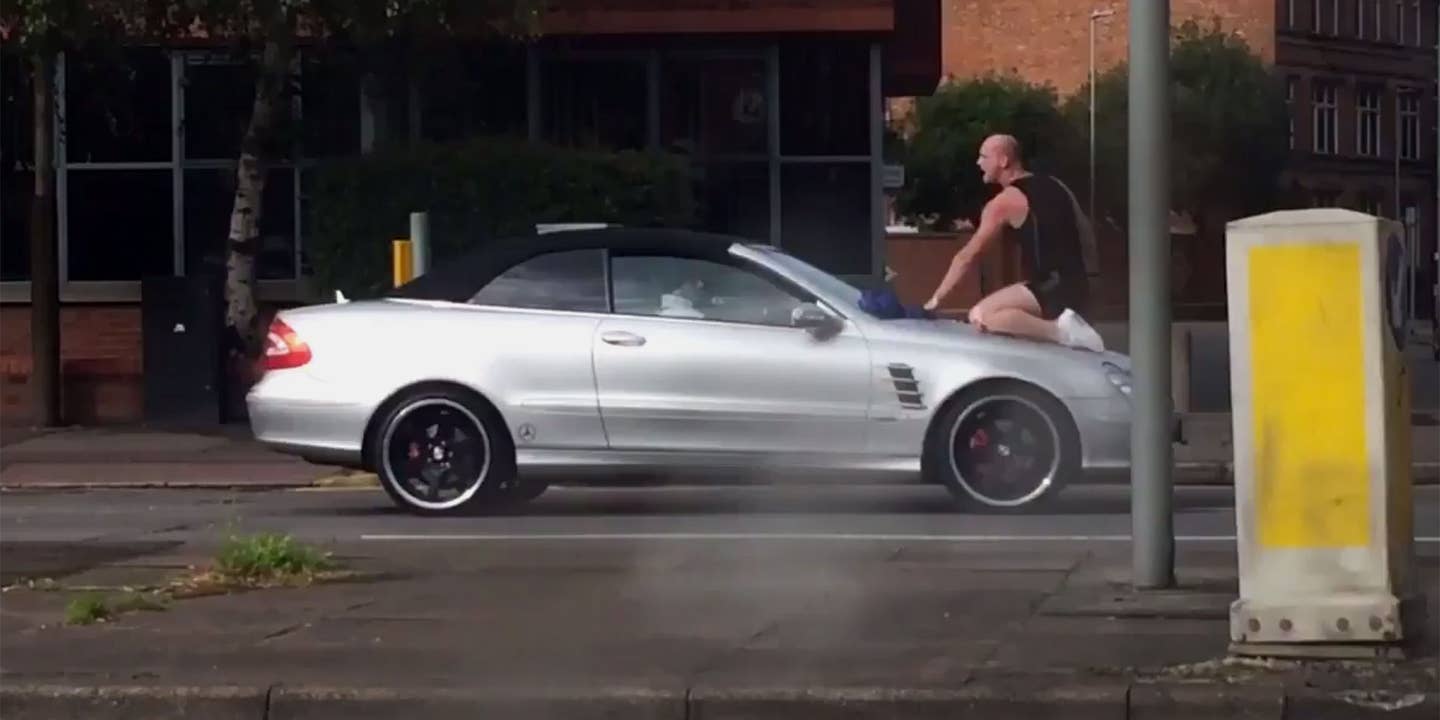 Watch This Crazy Man Headbutt a Moving Mercedes CLK