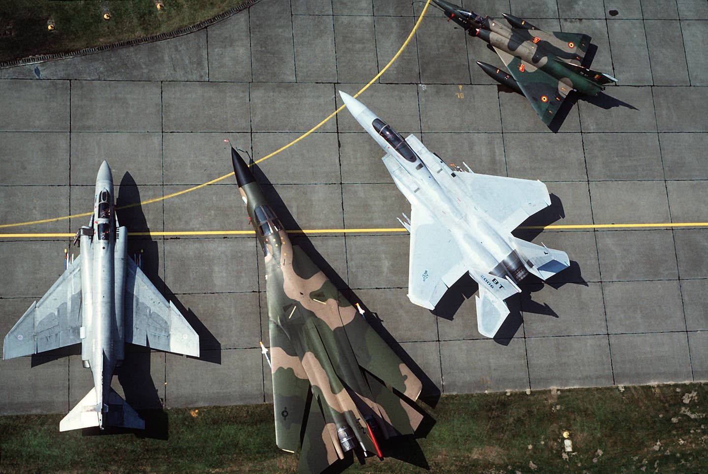 an_aerial_view_of_a_multinational_multiaircraft_static_display_including_left_to_right_an_f-4_phantom_ii_an_f-111_an_f-15_eagle_and_a_belgian_mirage_df-st-87-10648.jpg