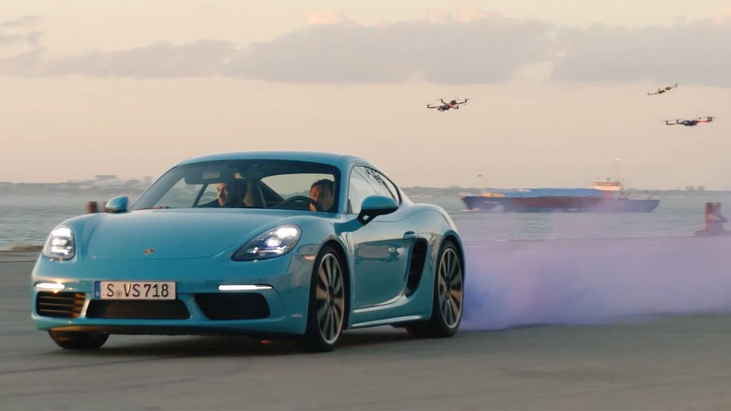 Watch the Porsche 718 Cayman S Race a Swarm of Drones