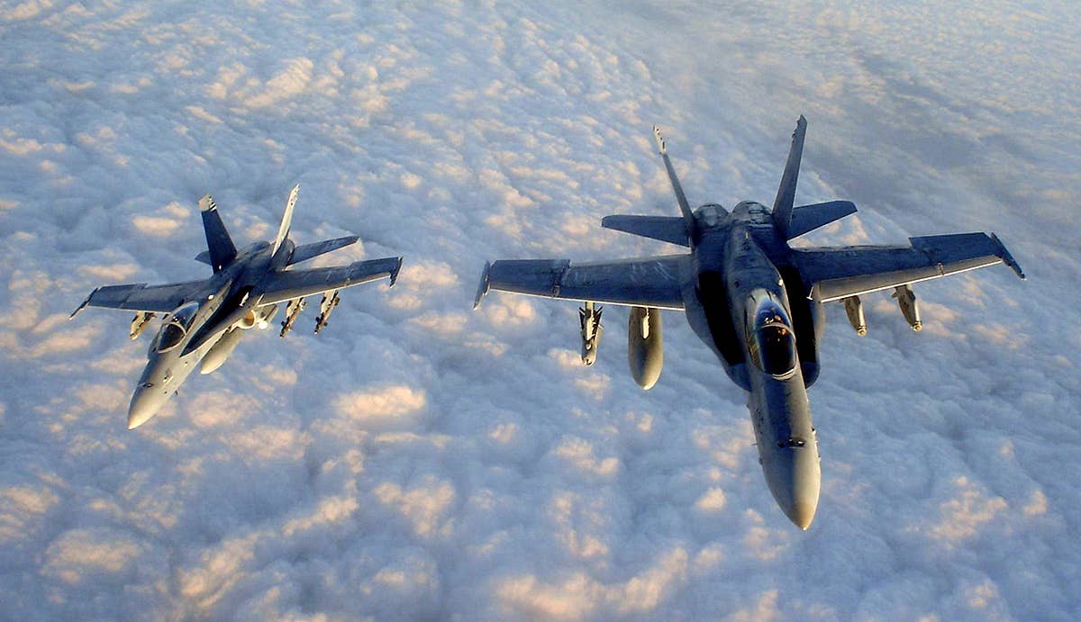 us_navy_041212-n-0000x-003_two_f-a-18c_hornets_assigned_to_the_gunslingers_of_strike_fighter_squadron_one_zero_five_vfa-105_fly_in_formation_after_being_refueled_by_an_air_force_kc-130_tanker.jpg