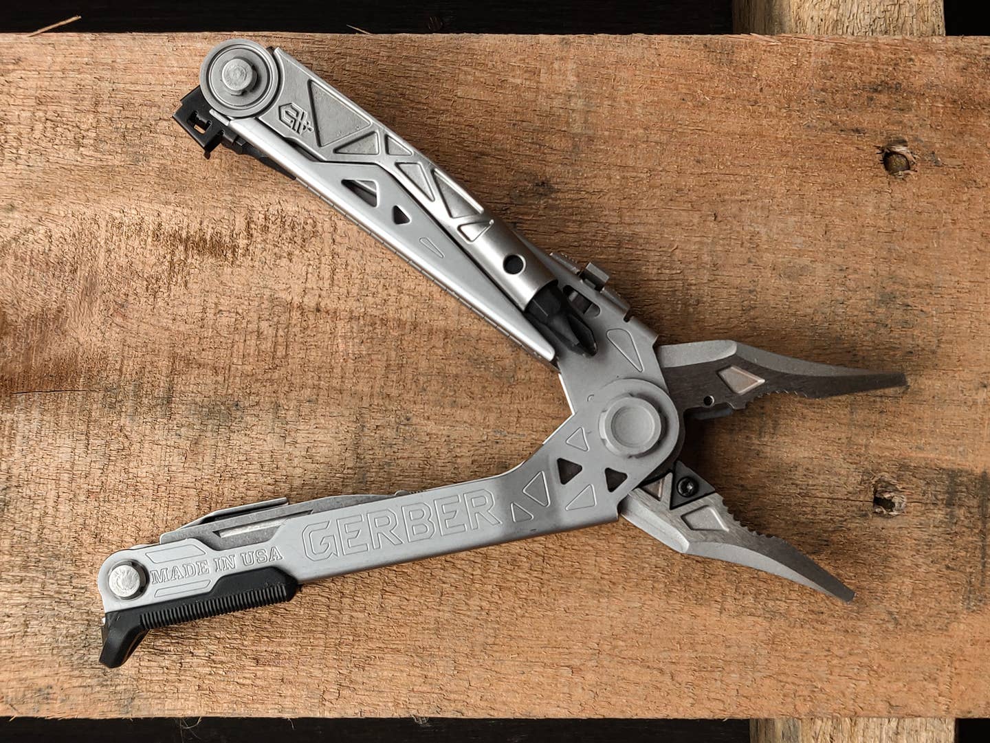 Gerber's center-drive plus multitool laying on a wood plank